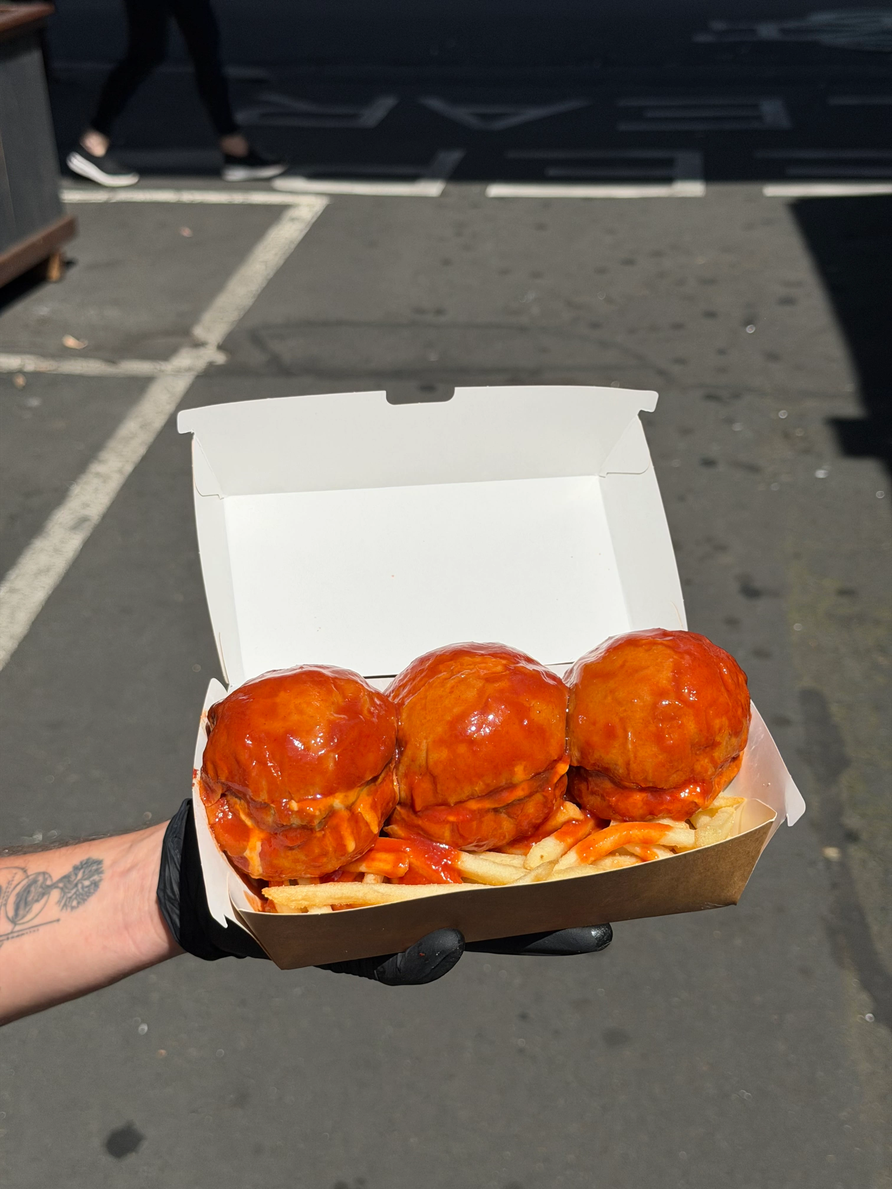 Sauce-soaked SOSMOS burgers, fresh from the truck at Queen Victoria Market