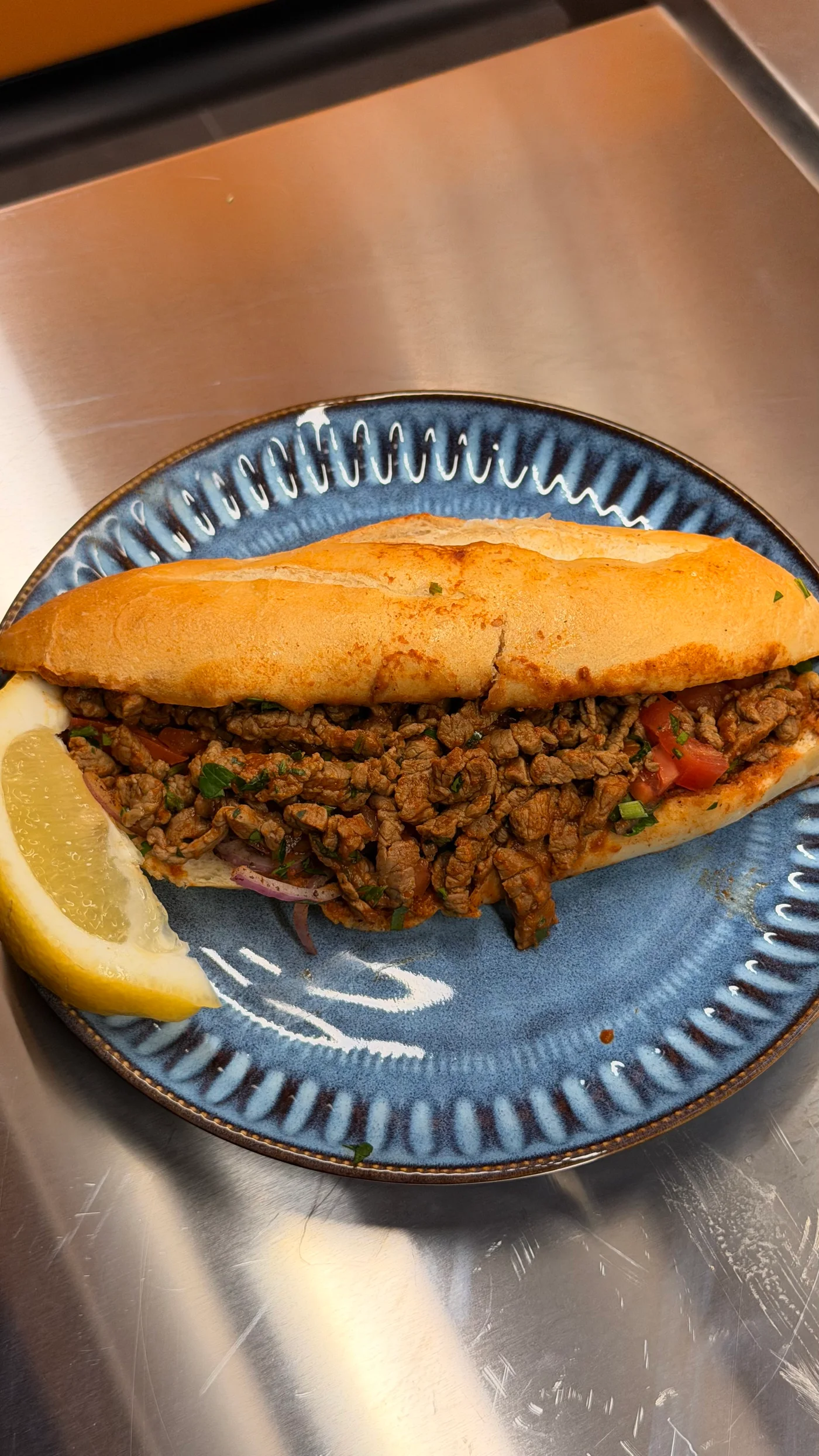 Tantuni roll with seasoned filling, herbs and lemon